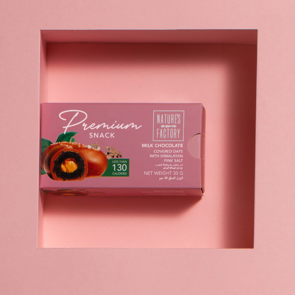 Natures own Factory chocolate covered date with himalayan pink salt, packaging on a pink background