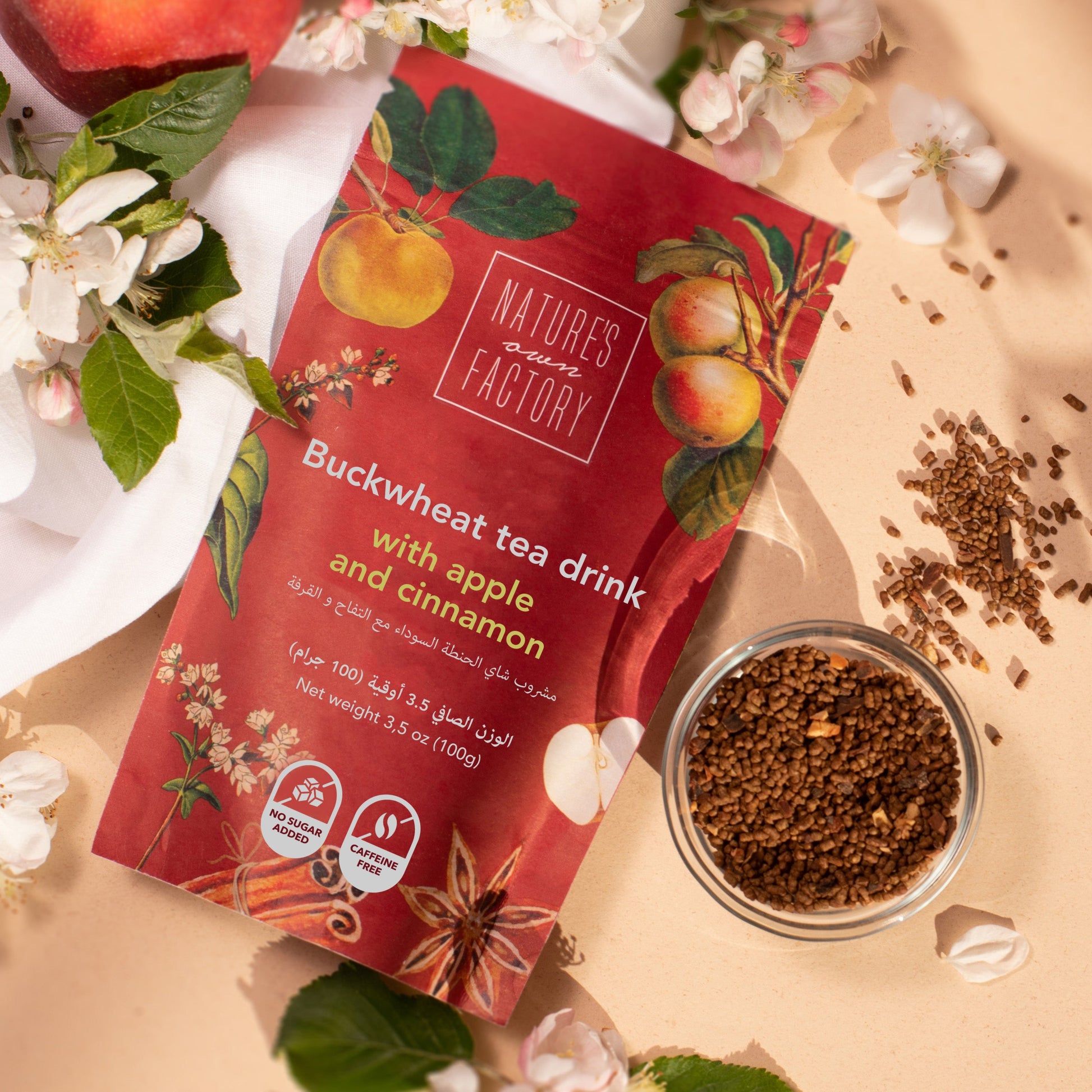 Nature's Own Factory buckwheat tea with apple and cinnamon, package with ingredients on a beige background