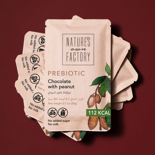 Prebiotic chocolate with peanuts packaging from Natures Own Factory on a red background