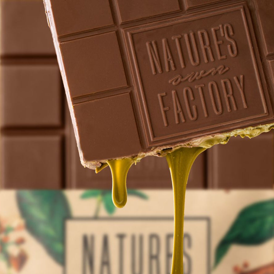 2Kg Chocolate bar with 'Nature's Own Factory' branding and Pistachio filling dripping.