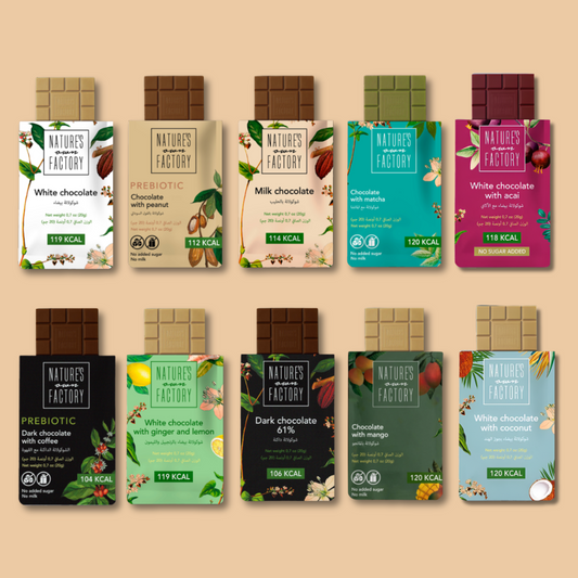 All available flavors of Nature's Own Factory chocolate bars on a beige background