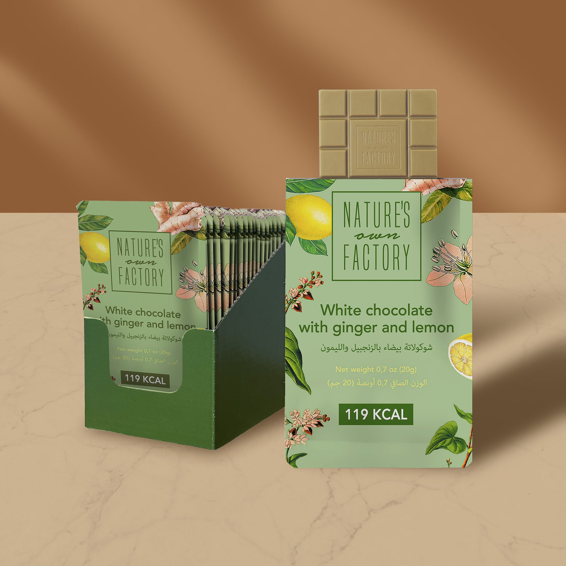 Nature’s Own Factory White Chocolate with Ginger and Lemon 24 packs 20g premium white chocolate bar made with natural ingredients, shown in elegant green packaging with lemon and floral illustrations.