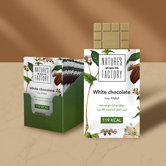 Nature’s Own Factory white chocolate bar with open retail display box on marble surface and soft brown background